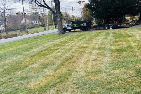 Crew performing seasonal lawn maintenance in Warwick, NY backyard